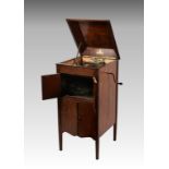 A mahogany cased free standing cabinet gramophone by Academy, having two sets of hinged doors to