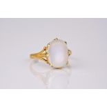 An 18ct yellow gold and moonstone ring, featuring a large cabochon moonstone held between 8 yellow