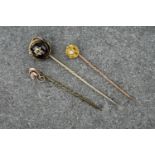 Three antique gold stick pins (3), including a pin with decorative, leaf detailing, a pin with