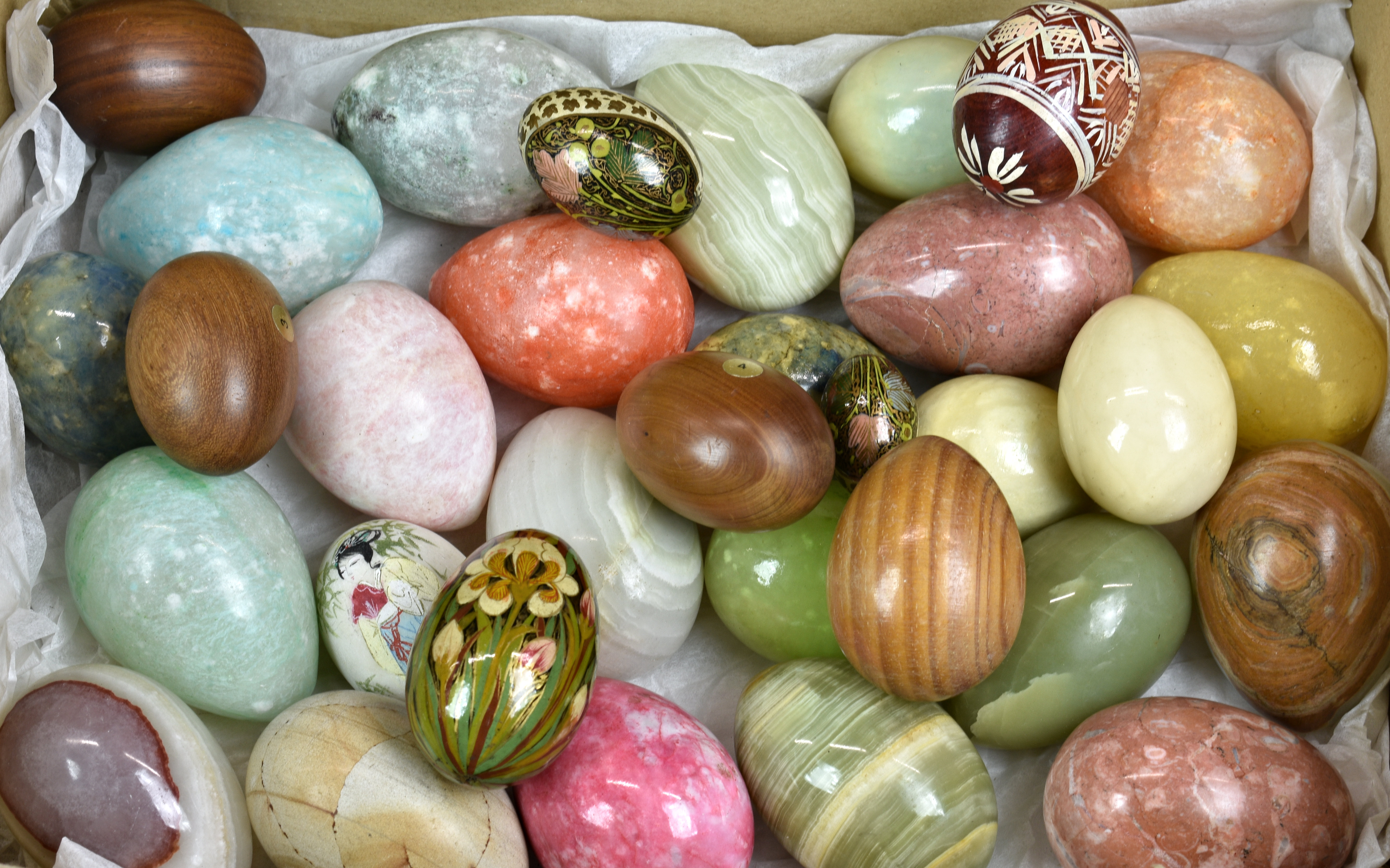 A large collection of natural carved semi-precious stone and wooden eggs. (36)