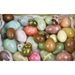 A large collection of natural carved semi-precious stone and wooden eggs. (36)