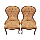 A pair of stained beech balloon backed showframe chairs.