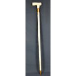 An antique style walking stick the T-handle finely carved with flowers, beneath, an engraved coat of