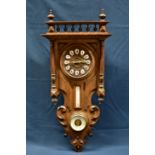 A late 19th century French wall clock with barometer and thermometer the mahogany and stained