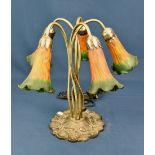 A Tiffany style five light table lamp with orange and green flower shades.