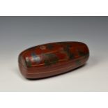 An Oriental red lacquer box fashioned as a gourd the lidded box adorned with a butterfly amidst a
