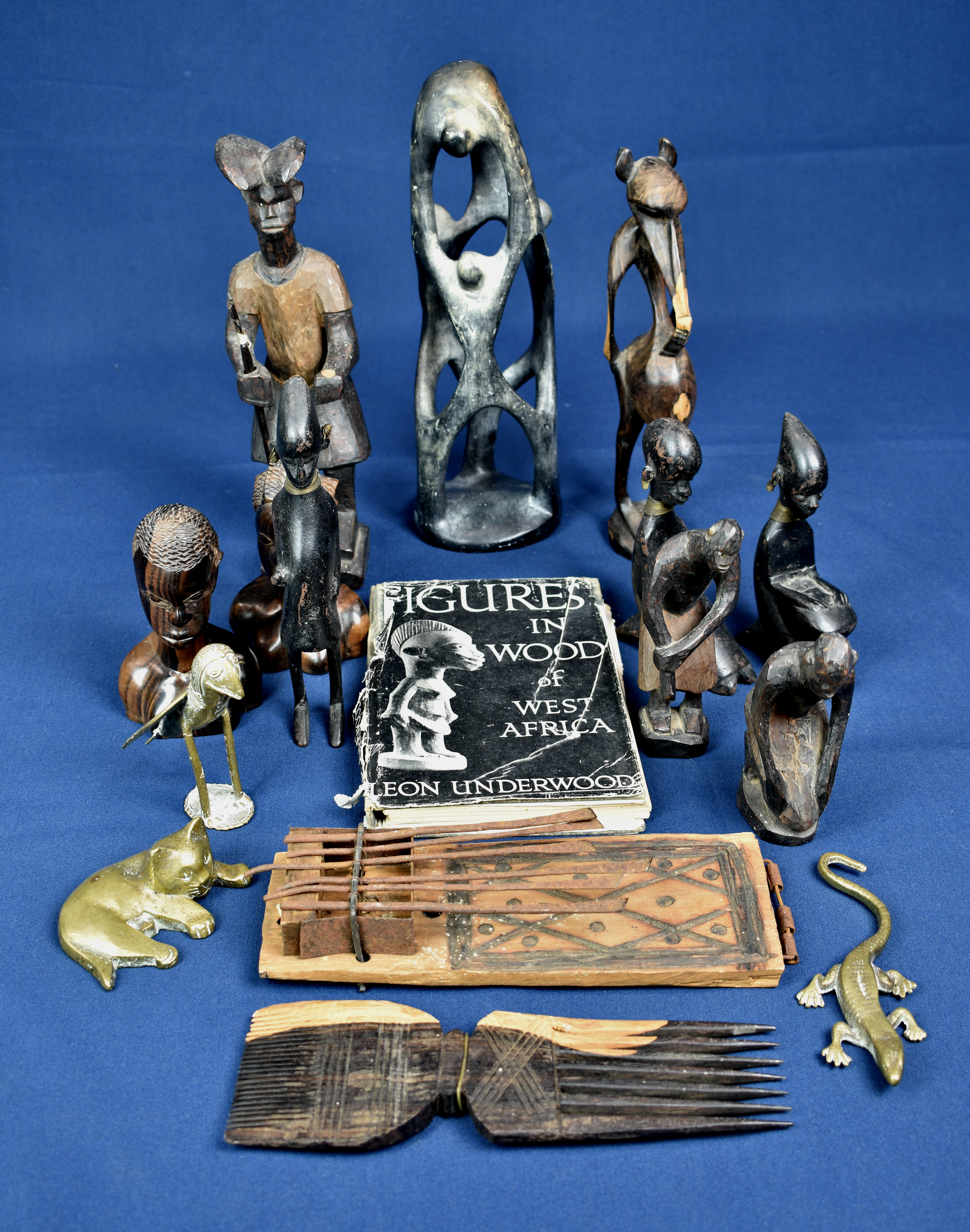 A small collection of African carved figures etc together with brass ornaments. (qty)