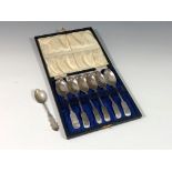 A cased set of George V silver teaspoons, Sheffield 1930, plus another spoon. (2)