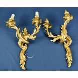 A pair of gilt metal rococo style light fittings.