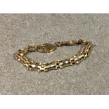 A 9ct gold gate link bracelet with heart padlock clasp