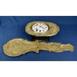 An antique French pressed brass wall clock