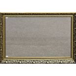 A wall mirror with floral gilt surround. 19.5 x 29.5ins