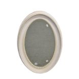 A Victorian oval white painted mirror with bevelled plate