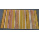 An orange toned rug 74¼ x 40¾in. (188.5 x 103.5cm.).