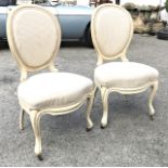 A pair of French painted carved beechwood bedroom chairs c.1900, the upholstery a/f. (2)