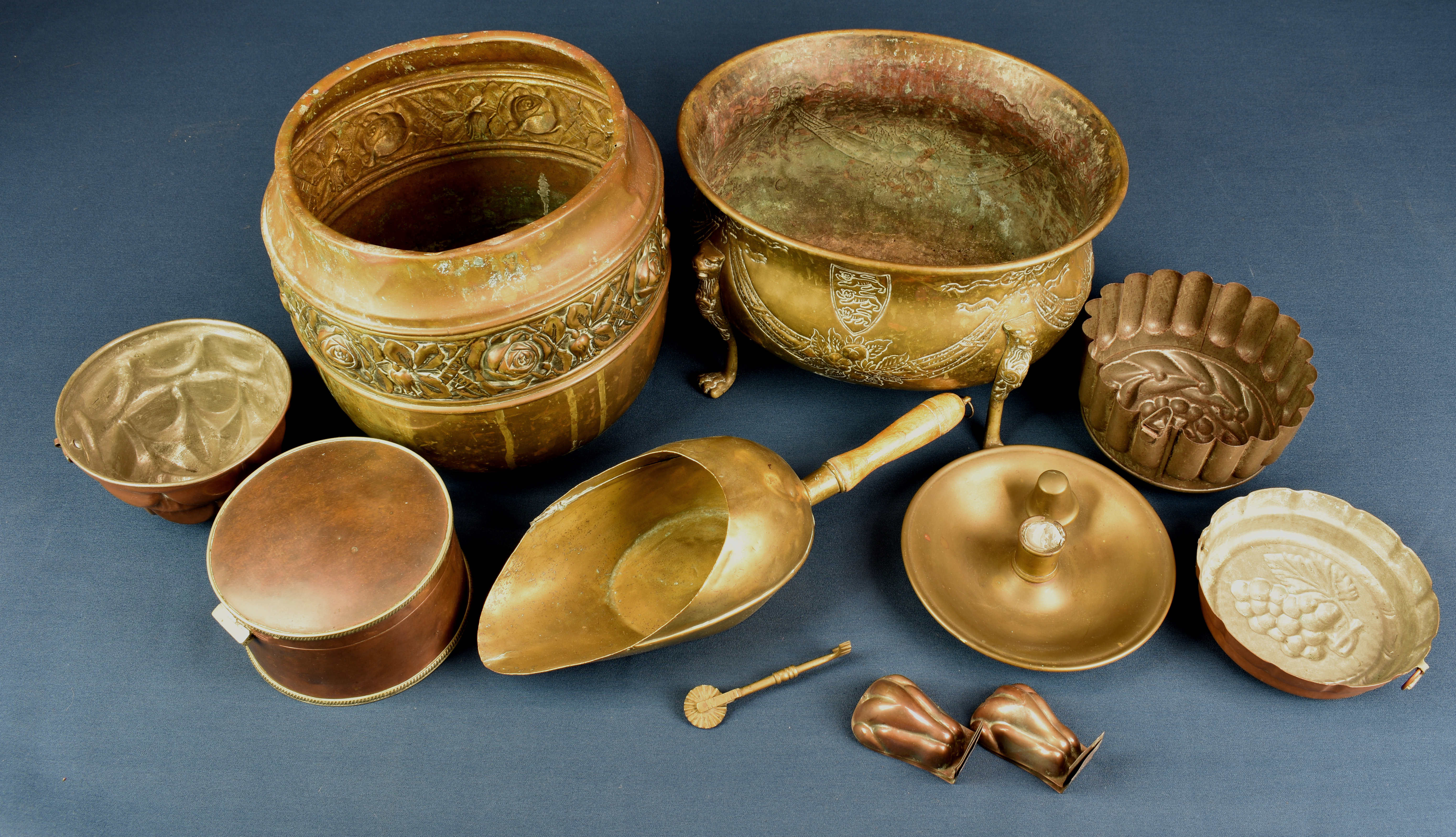 A collection of brass and copper ware comprising of a brass repoussé jardinière of oval form with