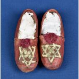A pair of Star of David red leather children's shoes.