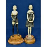 Two Art Deco style resin lady figurines both scantly clad in innocent poses, raised on stepped