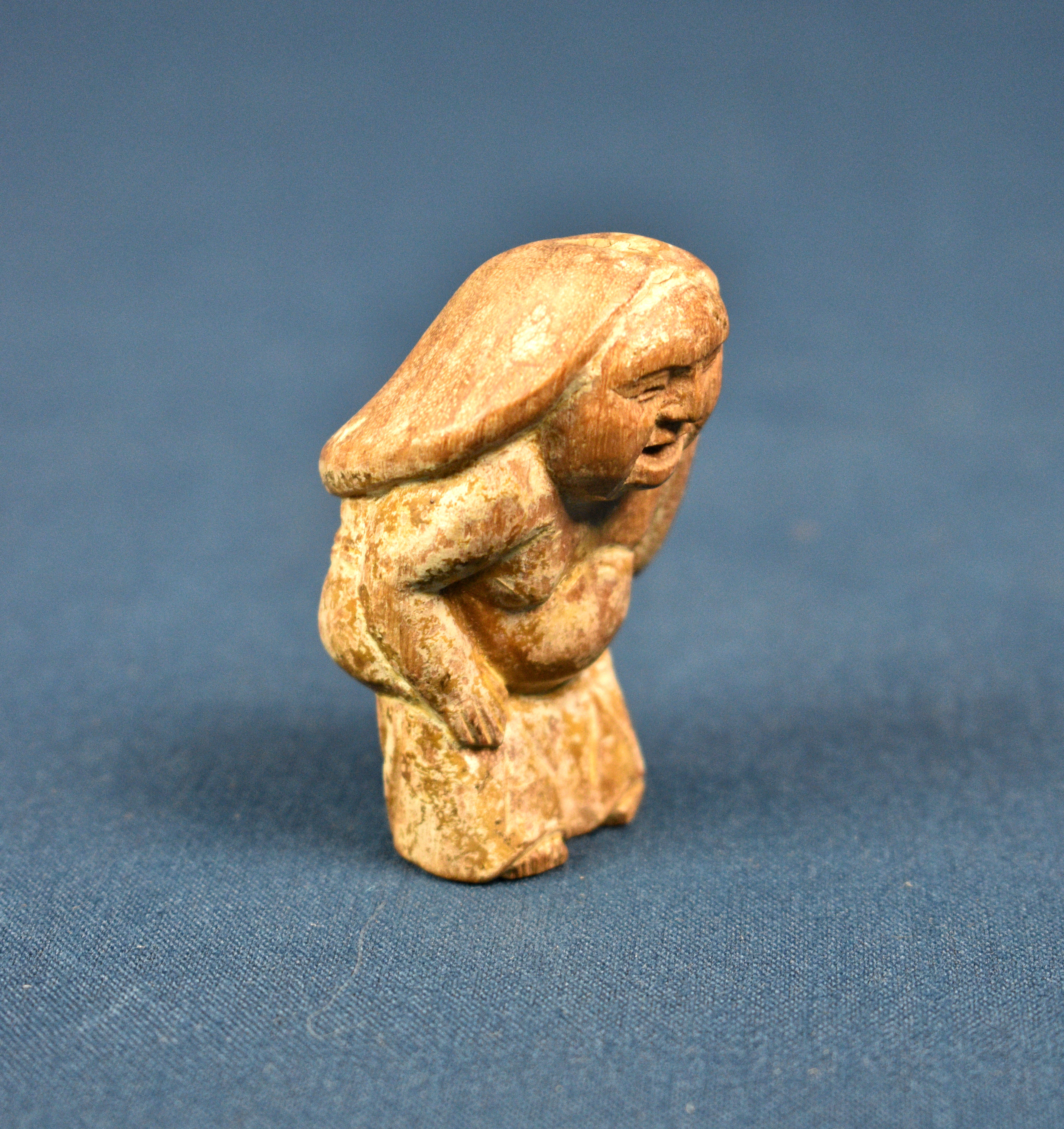 An Oriental miniature carved wooden erotic phallus figure.