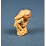 An Oriental miniature carved wooden erotic phallus figure.
