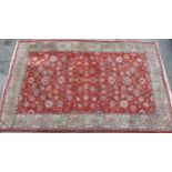 A large Persian style rug third quarter 20th century, the red ground with all over floral and vine