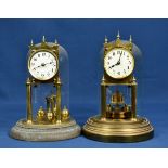 Two brass anniversary clocks with glass domes early to mid 20th century, one signed Gustav Becker,
