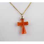 A carnelian cross pendant late 19th / early 20th century, with rolled gold mount, 4cm. long, on a