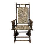 A late Victorian sprung-base rocking chair with bobbin turned frame