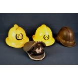 A Hendry of Glasgow leather fire helmet plus two Guernsey fire helmets, dated 1974 and 1988 and a