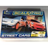 A Scalextric Street Cars Porsche 997 GT3 RS set used, contains one original car and an additional