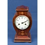 An Edwardian inlaid mahogany mantel clock the ivory enamel Roman dial within a vase shaped case with