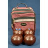 A set of four Henselite Championship lawn bowls 4 15/16 - 917-BP, contained in maroon carrying bag.