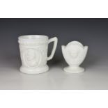 A Punch & Judy milk glass mug c.1880/1890, probably Sowerby, the white pressed glass mug depicting