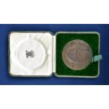 A cased bronze Commemorative Medallion from troop transport SS Queen Mary the obverse reading