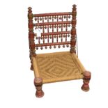 An Indian painted low chair probably early 20th century, the turned legs and uprights with bobbin