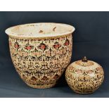 A Chinese black ground ovoid jar and cover and matching jardiniere (2)