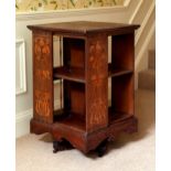 An Edwardian Art Nouveau style oak and marquetry revolving bookcase, the square serpentine top and