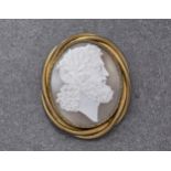 A gold plated shell cameo brooch of a Greek God, the shell cameo carved with a bearded man and
