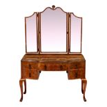 An Art Deco period Queen Anne revival burr walnut dressing table, the shaped triple plate mirror