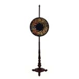 A William IV carved rosewood pole screen, the circular unglazed petit point floral screen on a