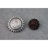 A pair of Victorian brooches, one consisting of silver backed, rose cut garnets and the other of