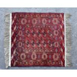 A small Tekke Bokhara rug, worked in madder, dark blue, red, ivory and brown, the two rows of five