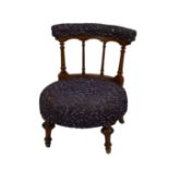 A late Victorian walnut nursing chair, the key incised, arcaded top rail over a turned four bar back