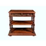 A Victorian carved oak three tier buffet, the top tier with carved egg and dart border over a pair