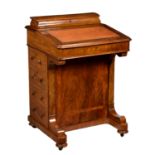A Victorian walnut Davenport, the burr walnut cross banded top with pen and stationary box to the