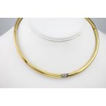 An 18ct yellow gold and diamond set hollow collar, of rigid form and with hidden clasp. The yellow