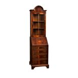 A reproduction George III style inlaid mahogany bureau bookcase, of small proportions, the broken