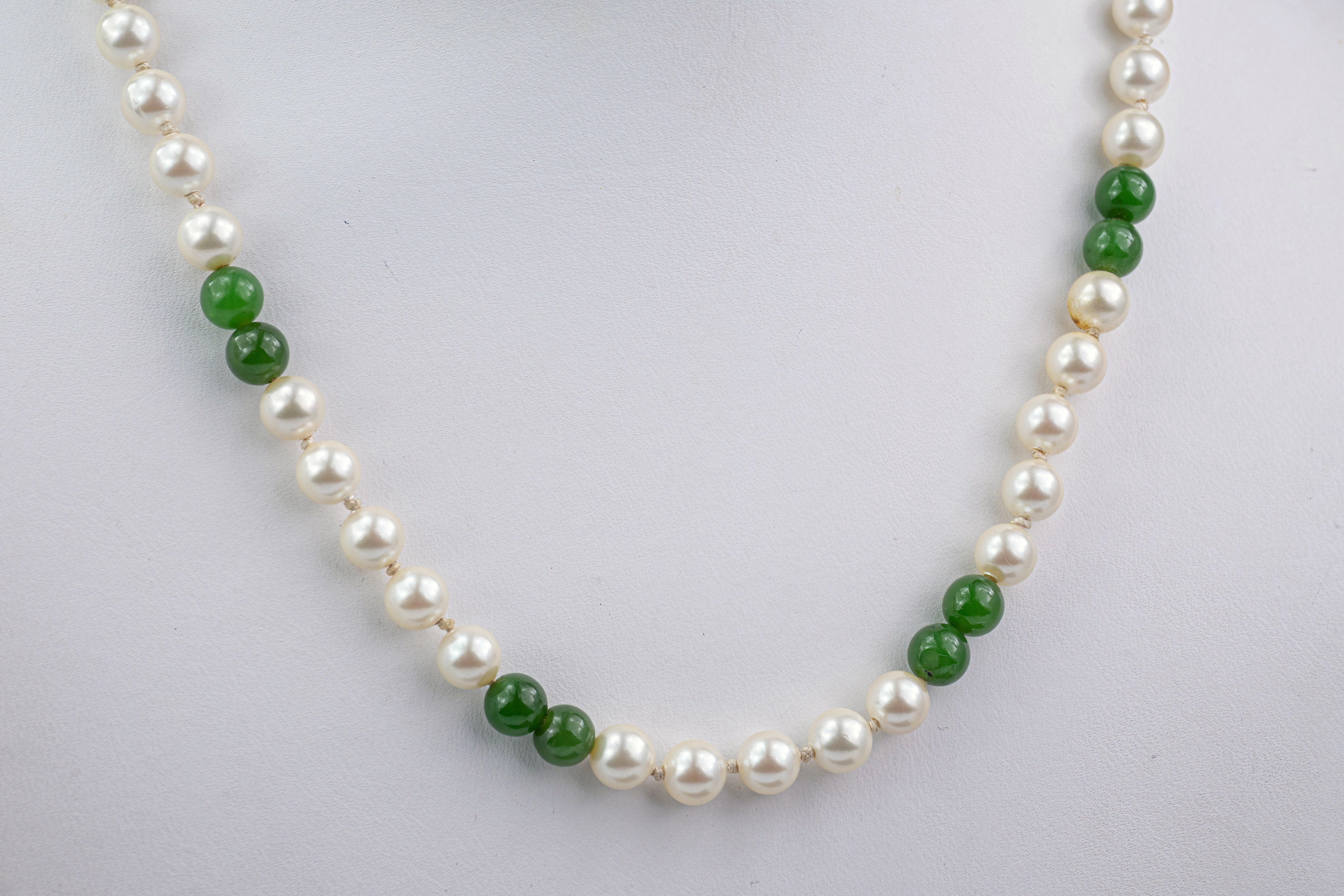 A 9ct gold, cultured pearl and jade necklace, each round pearl and jade bead measuring approximately