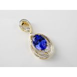 An 18ct yellow gold, Tanzanite and diamond pendant, the fine 12.5 x 9.5mm. oval cut Tanzanite and