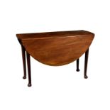 A George III red walnut oval gateleg dining table, the dropflap top raised on turned tapered legs